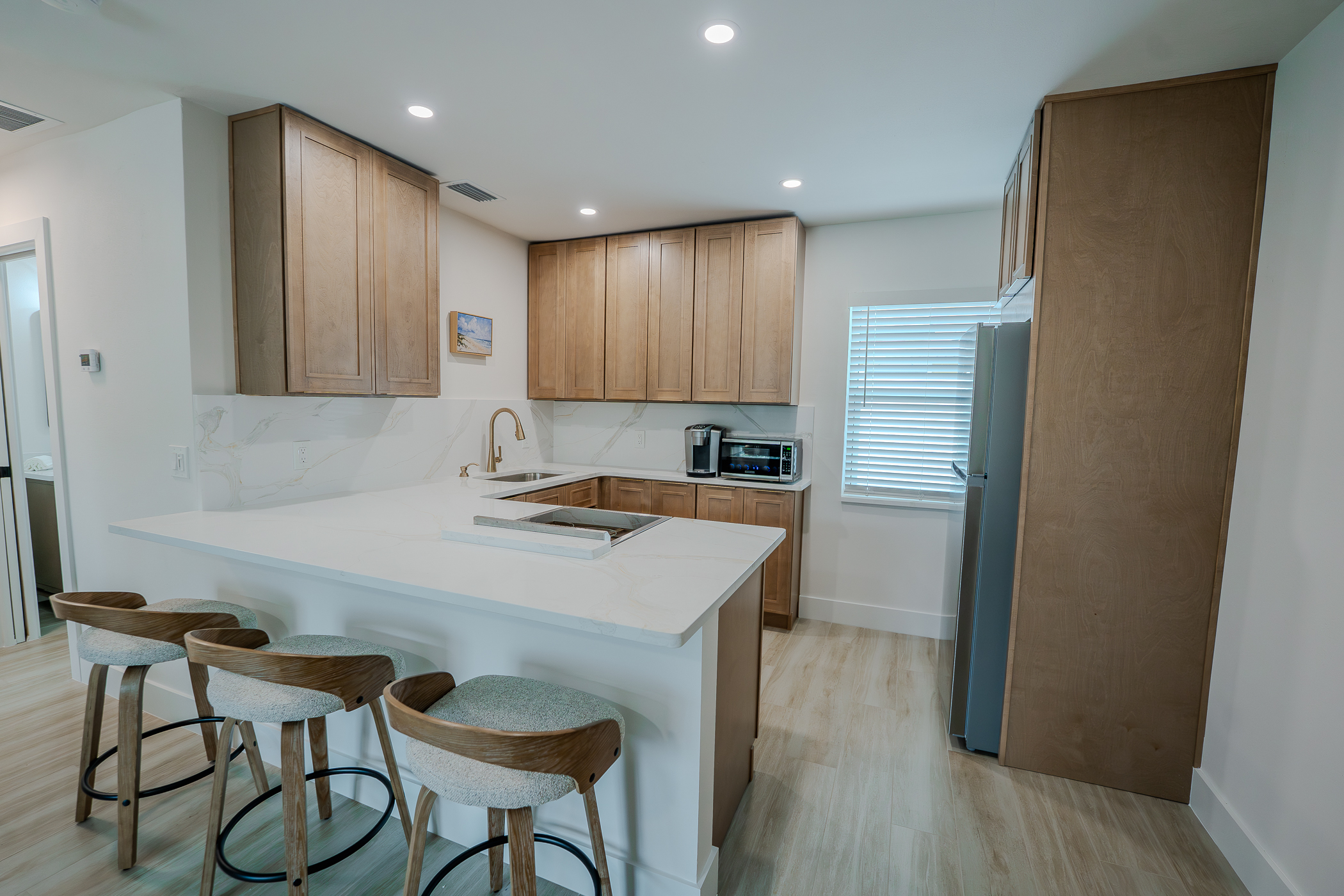 Custom designer kitchen renovation with cabinetry and stone surfaces in Pinellas County FL