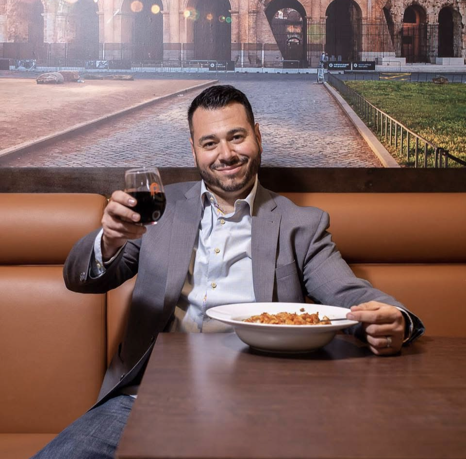 A restaurant manager calmly addressing a difficult situation on the floor while maintaining professionalism and hospitality.