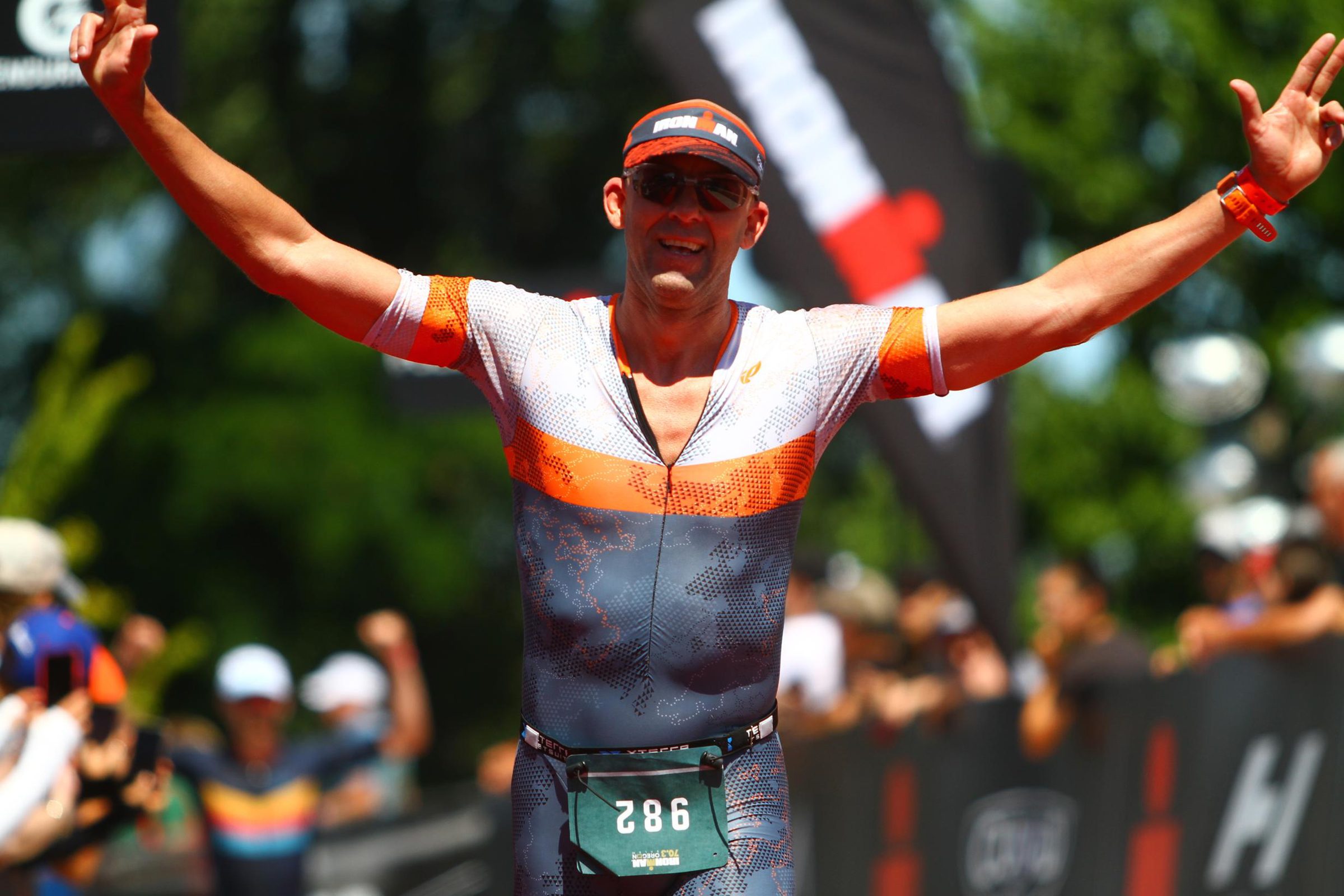 Triathlete celebrating at an Ironman finish line