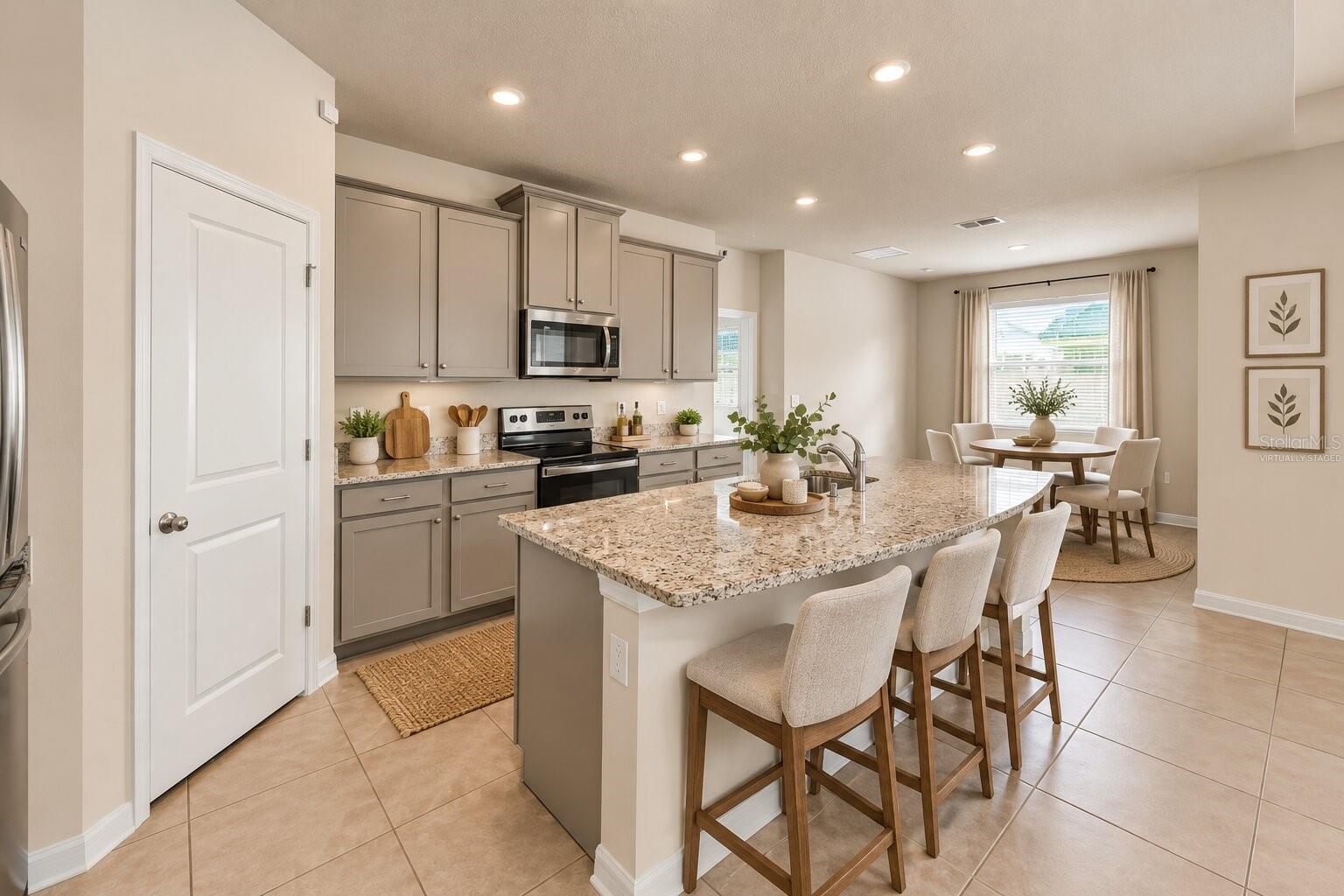 Kitchen and dining area at 12401 Shining Willow Street. Virtually staged.