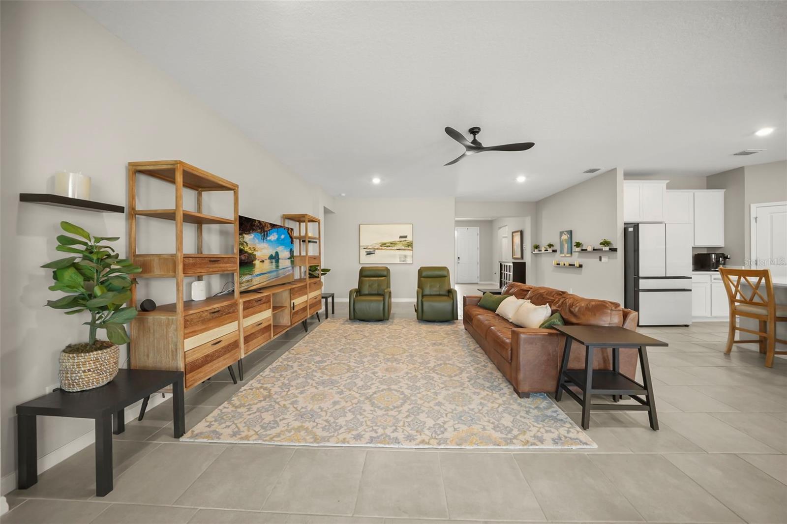 Living area at 6016 Wandering Willow Drive. The listing includes virtually staged photography.