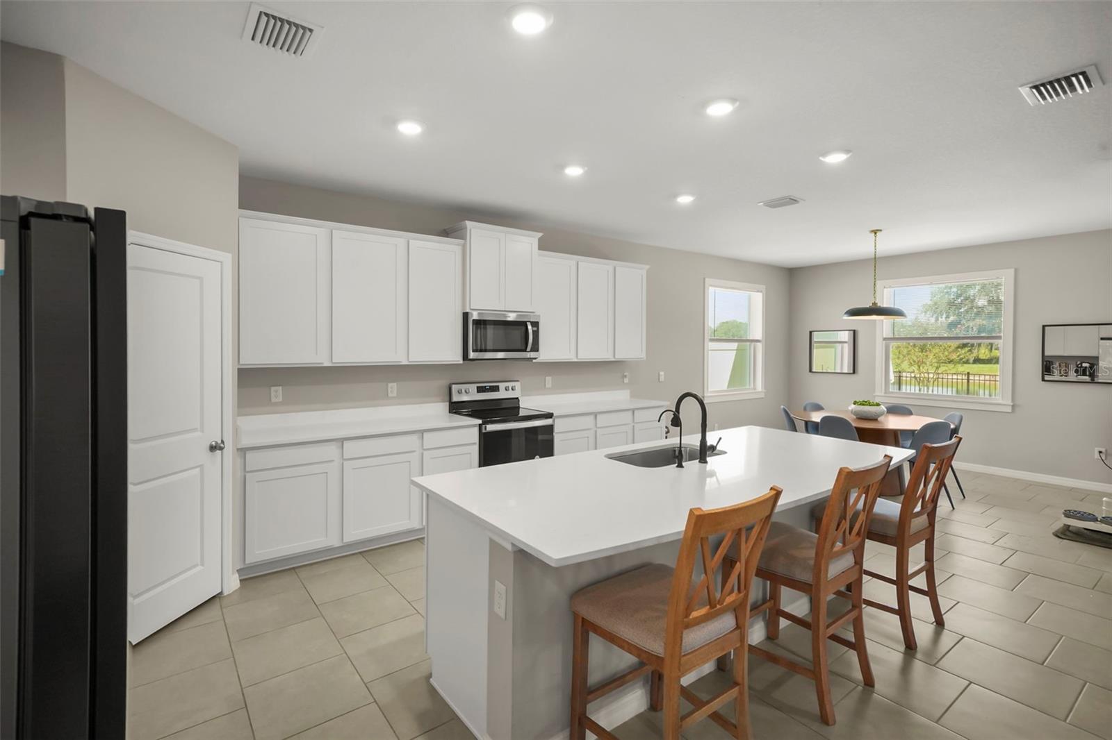 Kitchen at 6016 Wandering Willow Drive. The listing includes virtually staged photography.