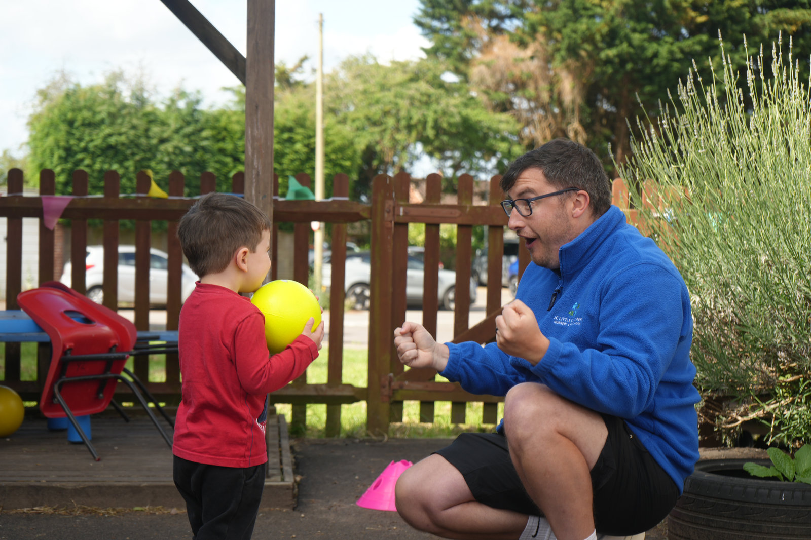 Coach playing ball games with a nursery child