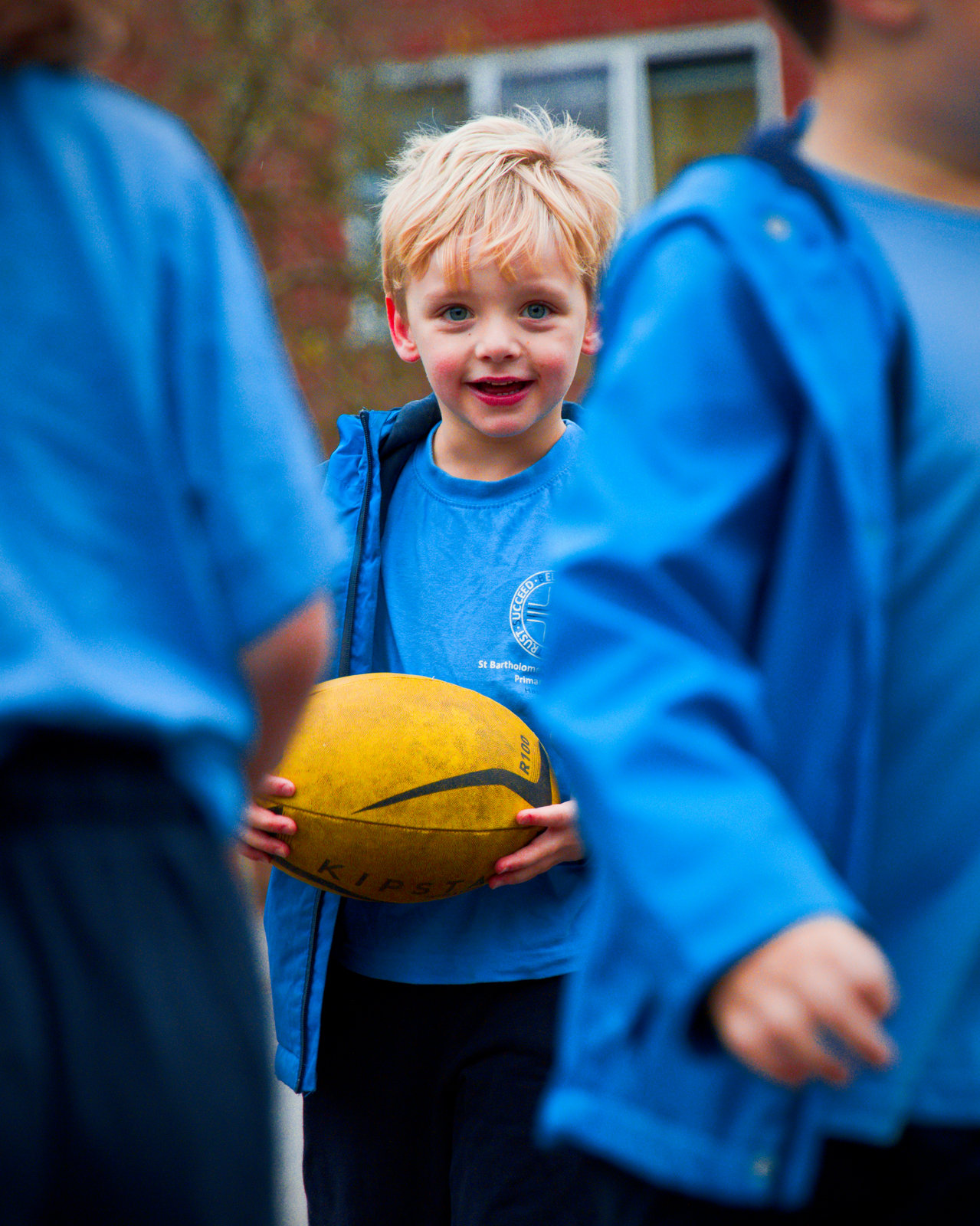 Smiling boy holding a rugby ball