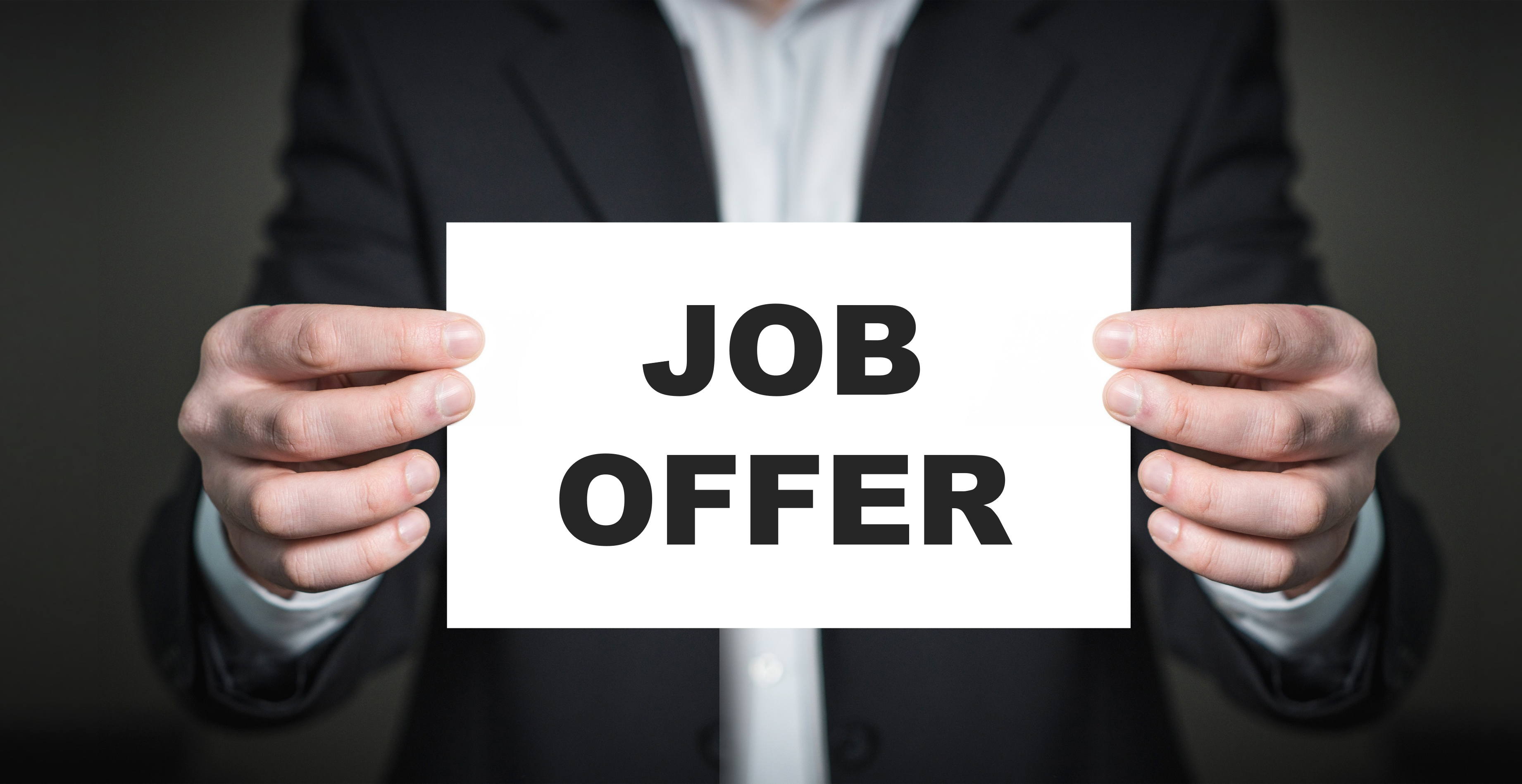 Person holding job offer card Person holding job offer card