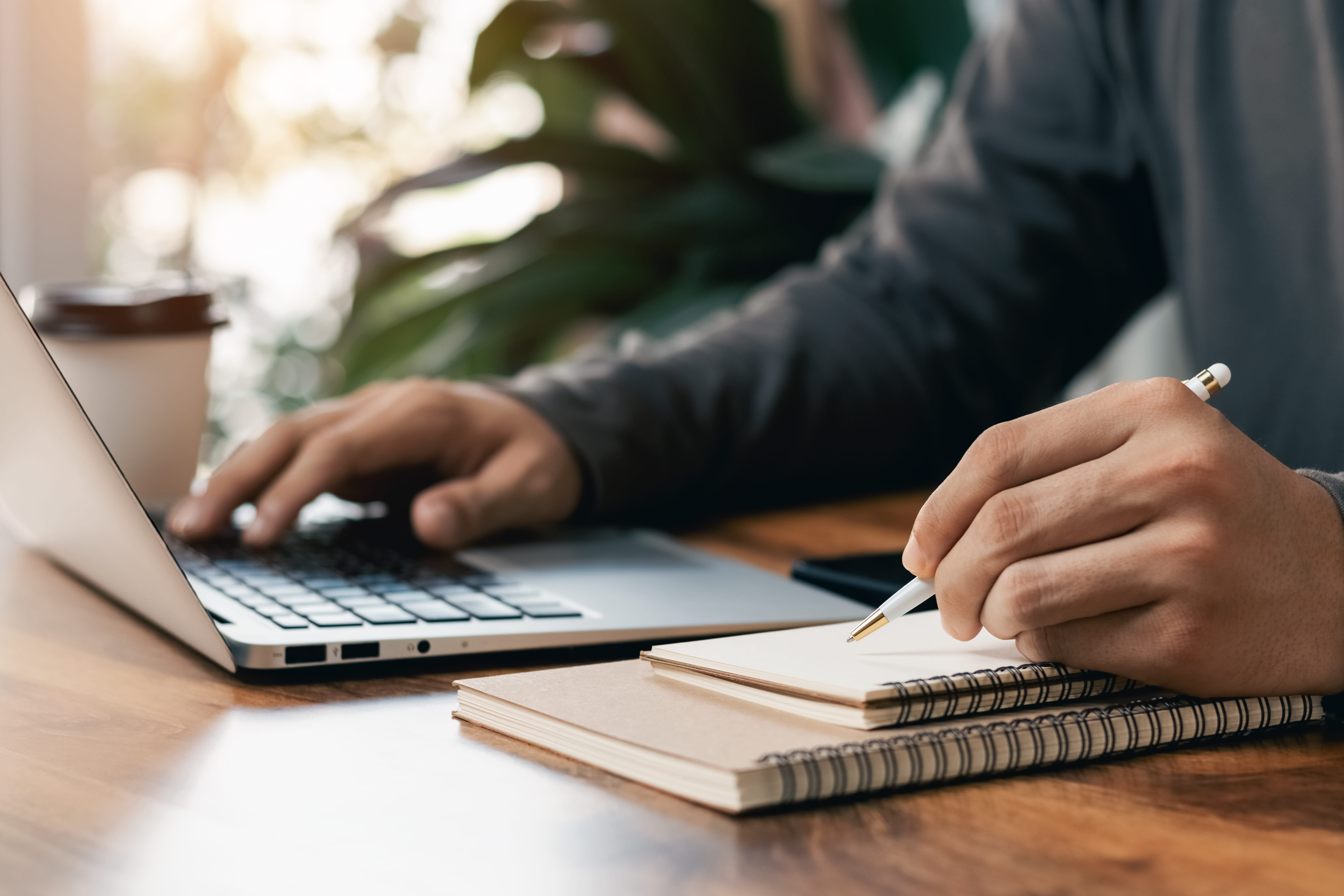 Manager typing up notes from performance meeting Manager typing up notes from performance meeting