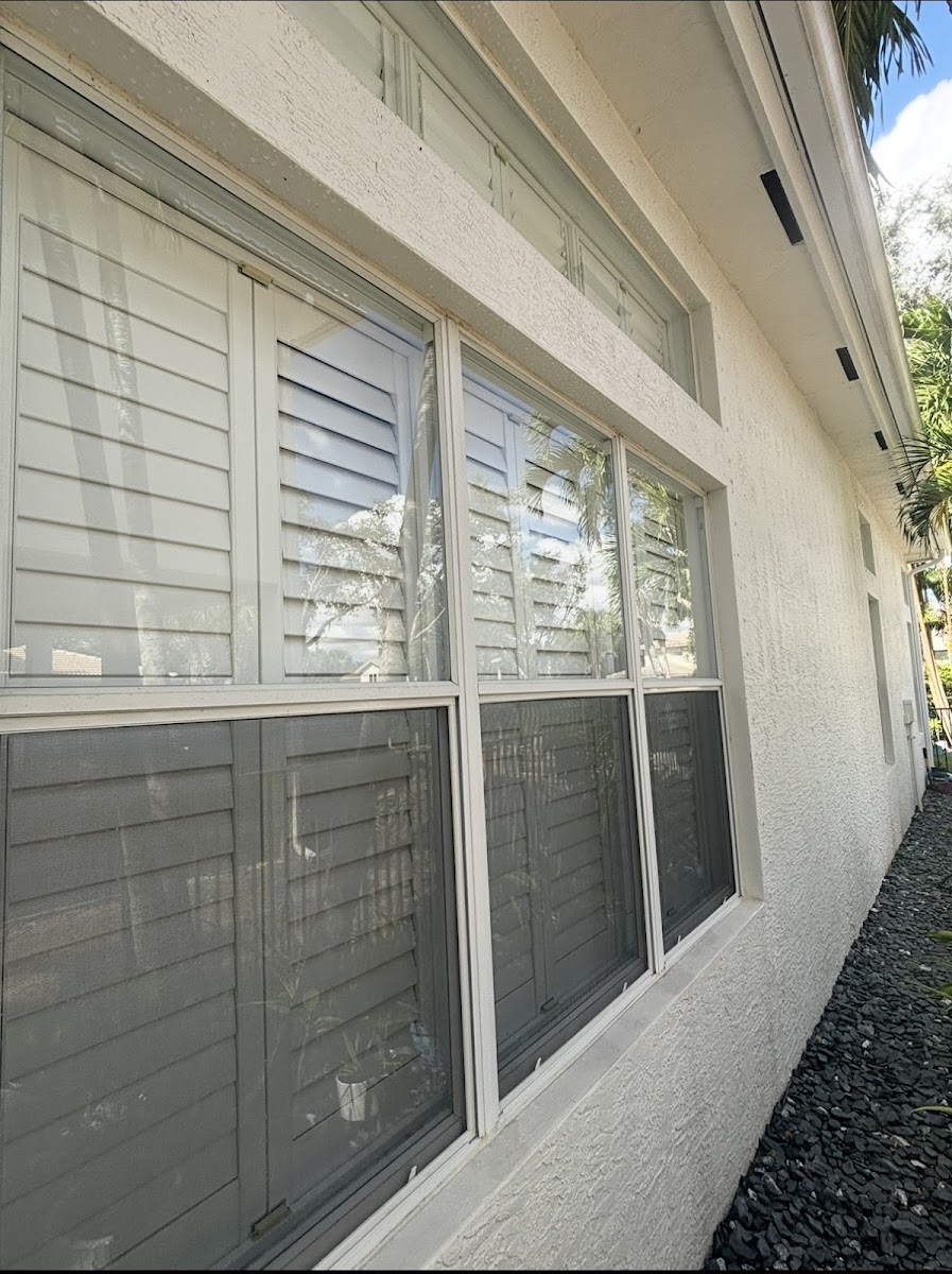 Close detail of a clean residential window with plantation shutters