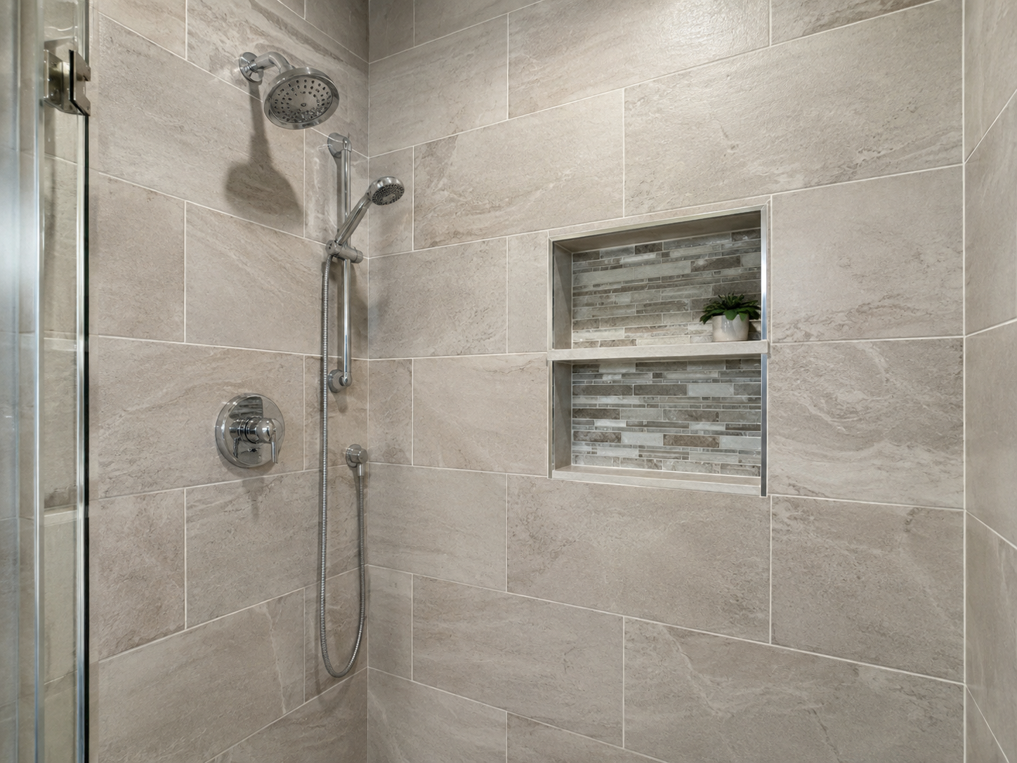 Tile shower surround with a recessed niche and accent band