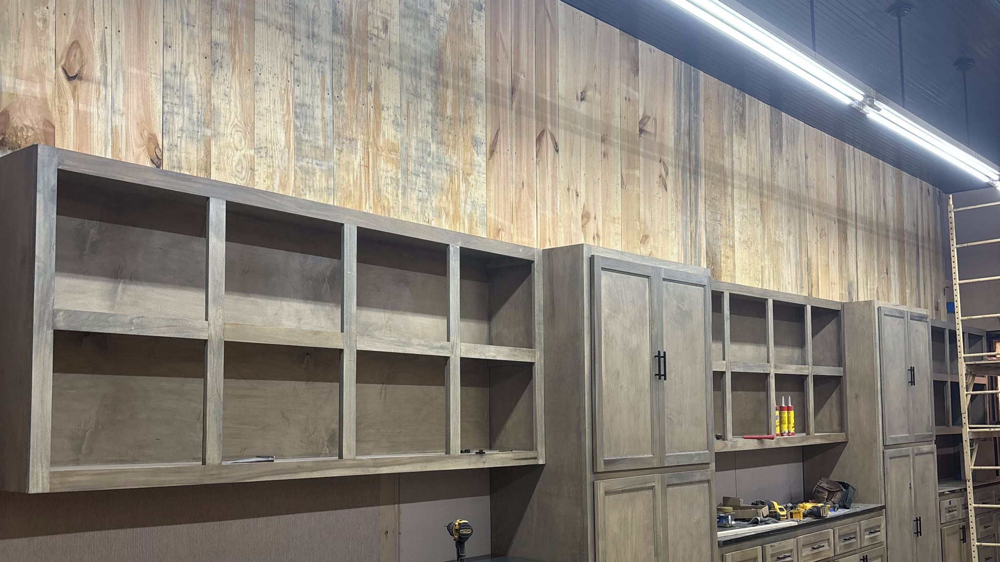 Stained custom cabinets and open shelving being built in the Boren Construction cabinet shop