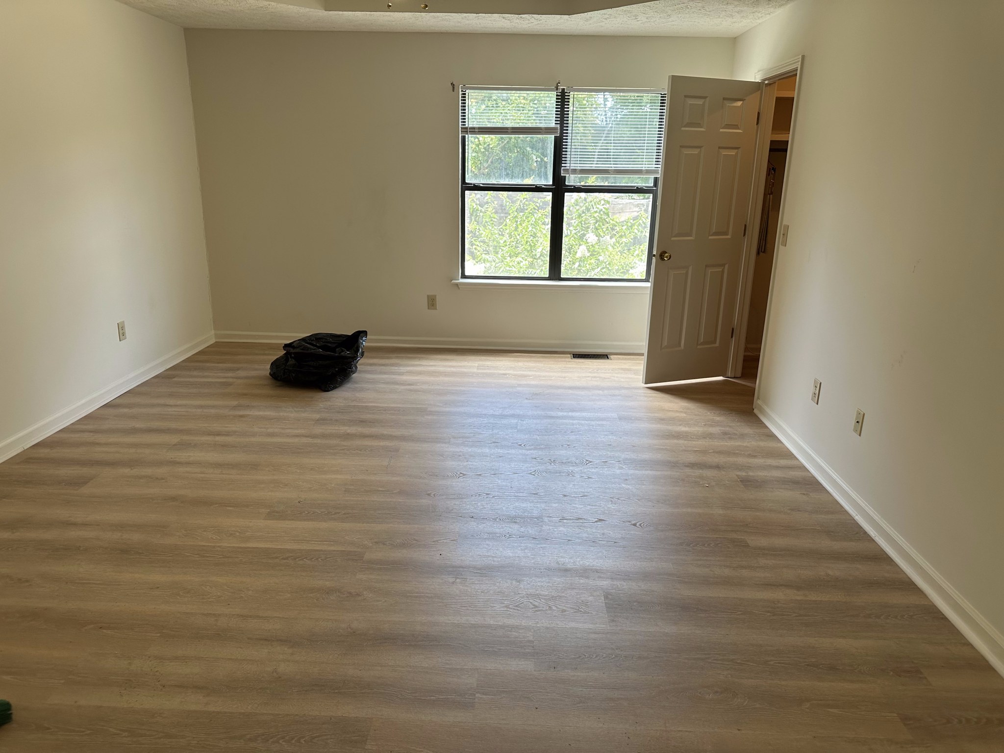 Finished room with new plank flooring by Boren Construction