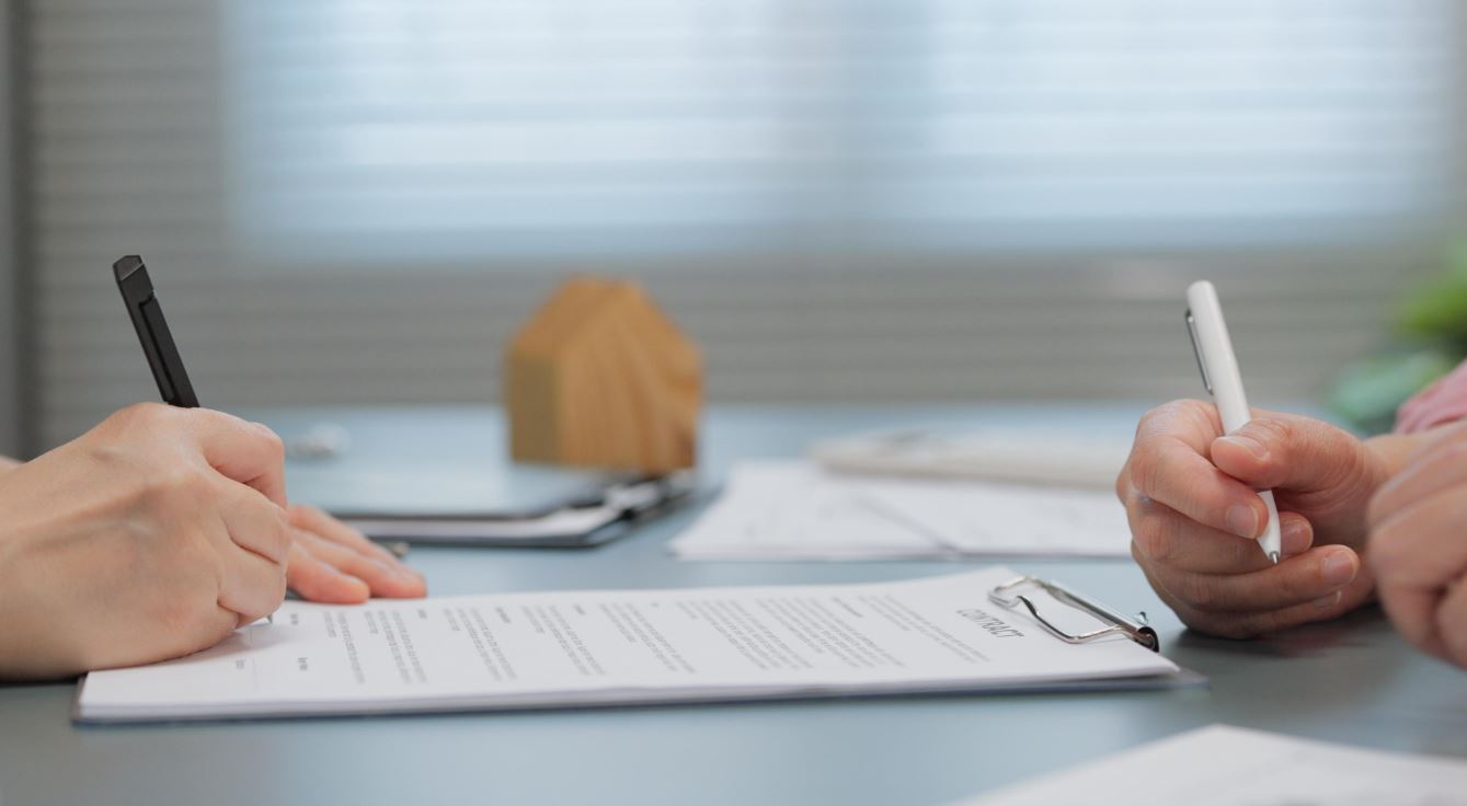 Reviewing mortgage and estate documents at a table