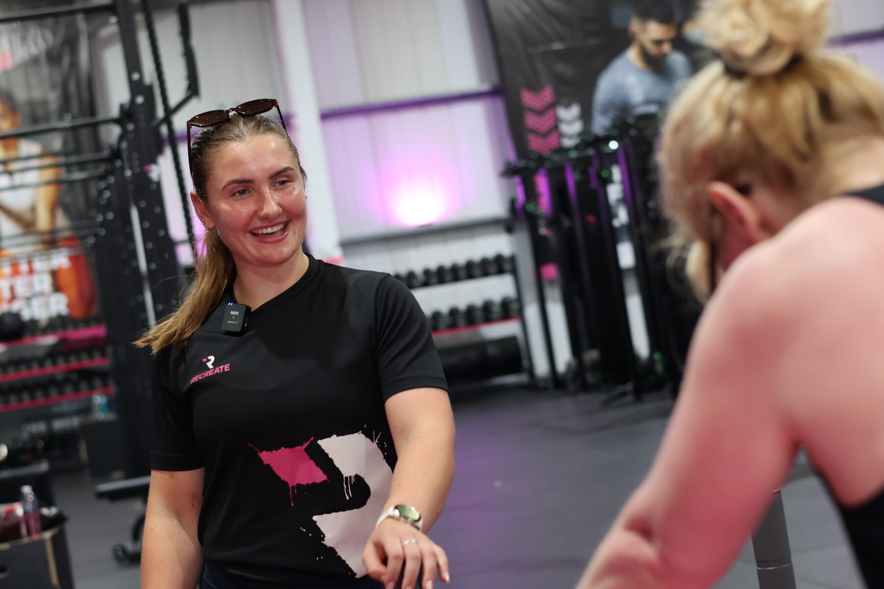 Recreate coach talking with a member in the gym