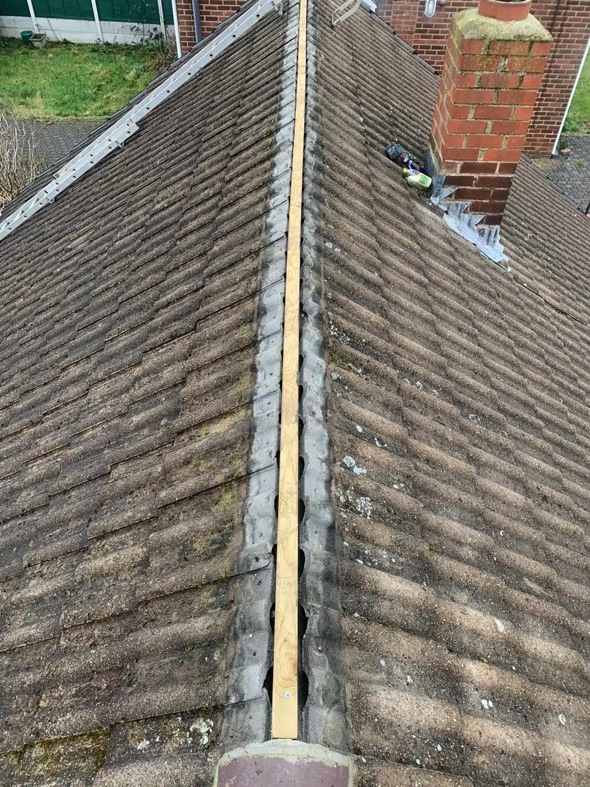 Roof ridge prepared after failing mortar has been removed