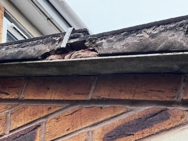 Old mortar breaking away from a roof edge