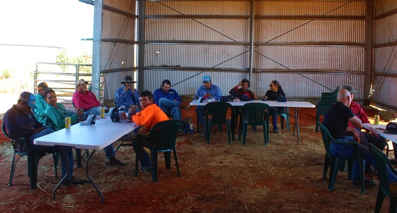 Group sitting under shelter