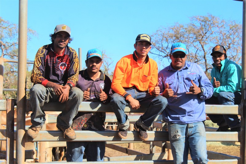 Men sitting on a fence