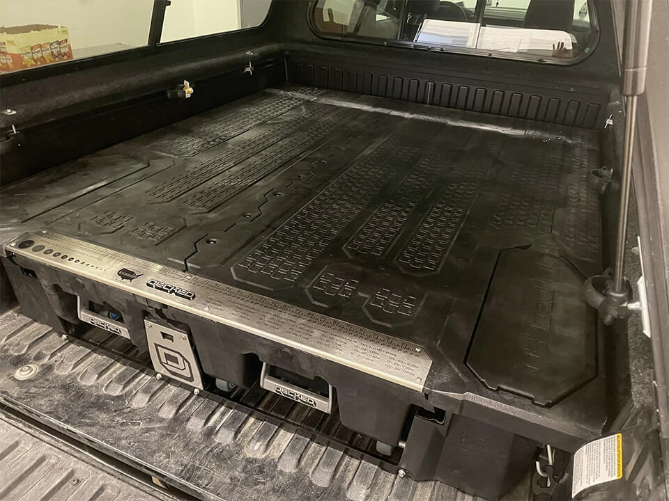 Truck with DECKED polyethylene drawer systems for secure tool and gear storage on the go.