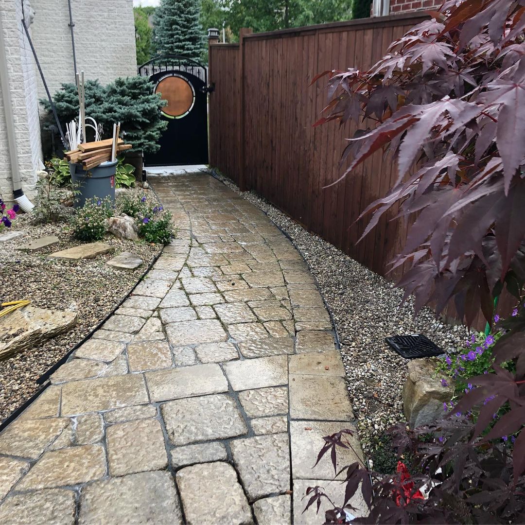 Curved paver walkway with garden border in London, Ontario
