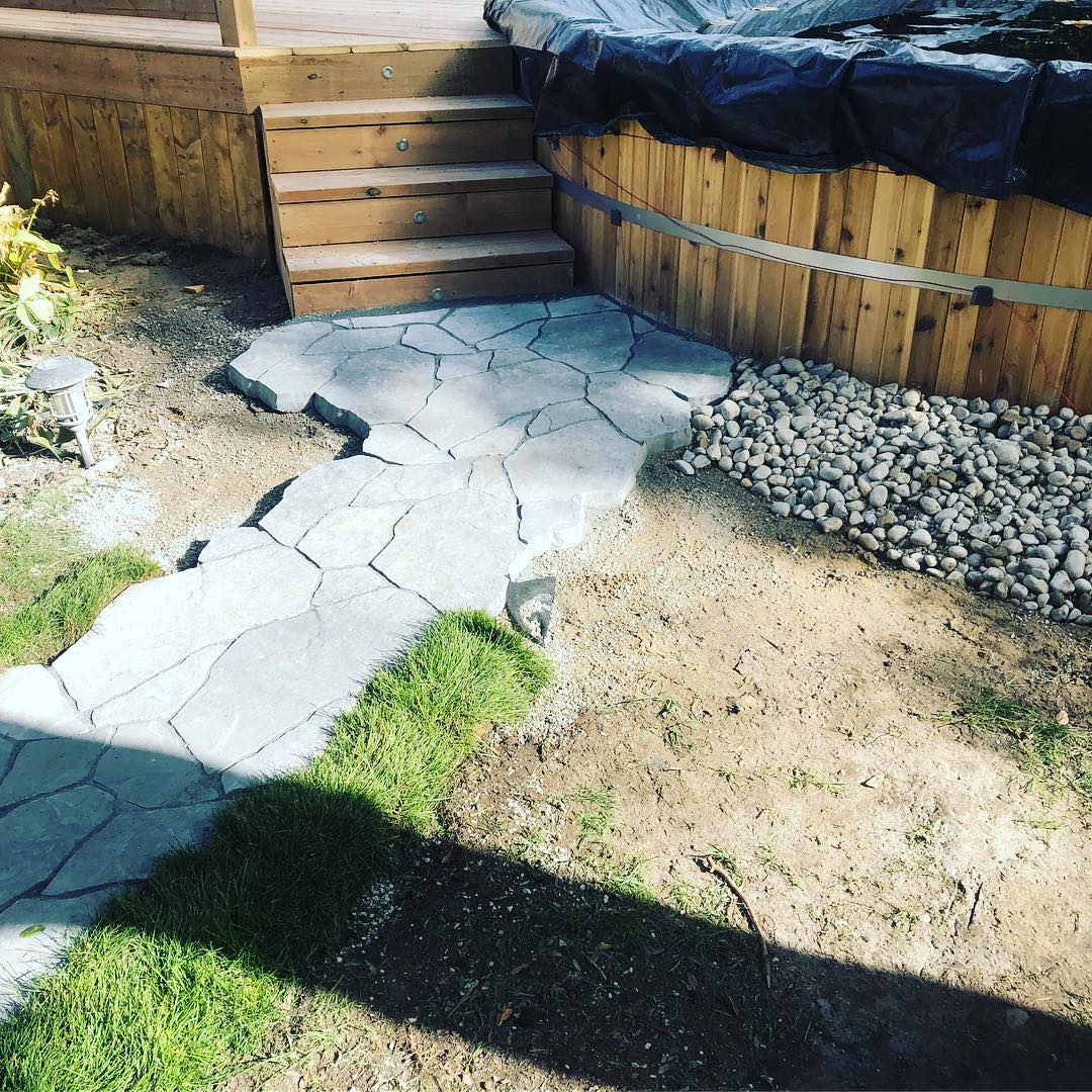 Natural flagstone garden path through a landscaped bed