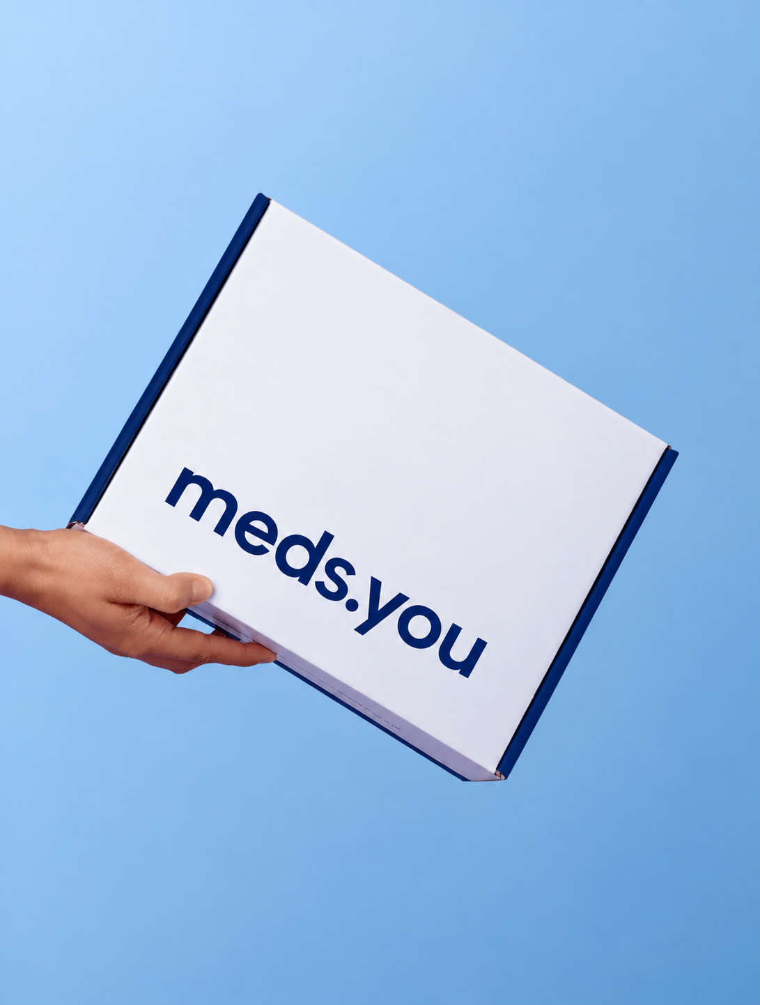 Hand holding a meds.you shipping box