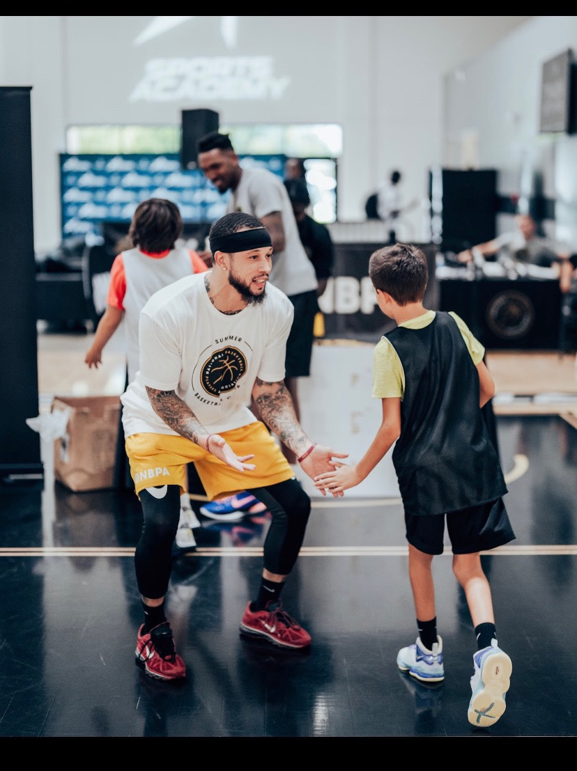 Coach Kevin Graham training a young athlete at Prime Impact Basketball