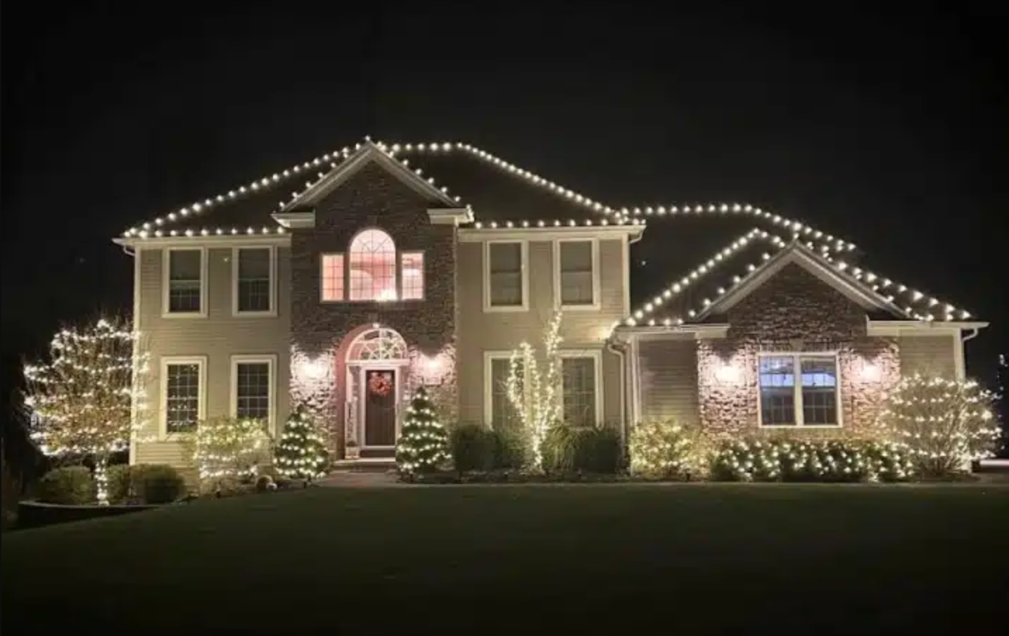 Christmas lights outlining a home's gables and gutters