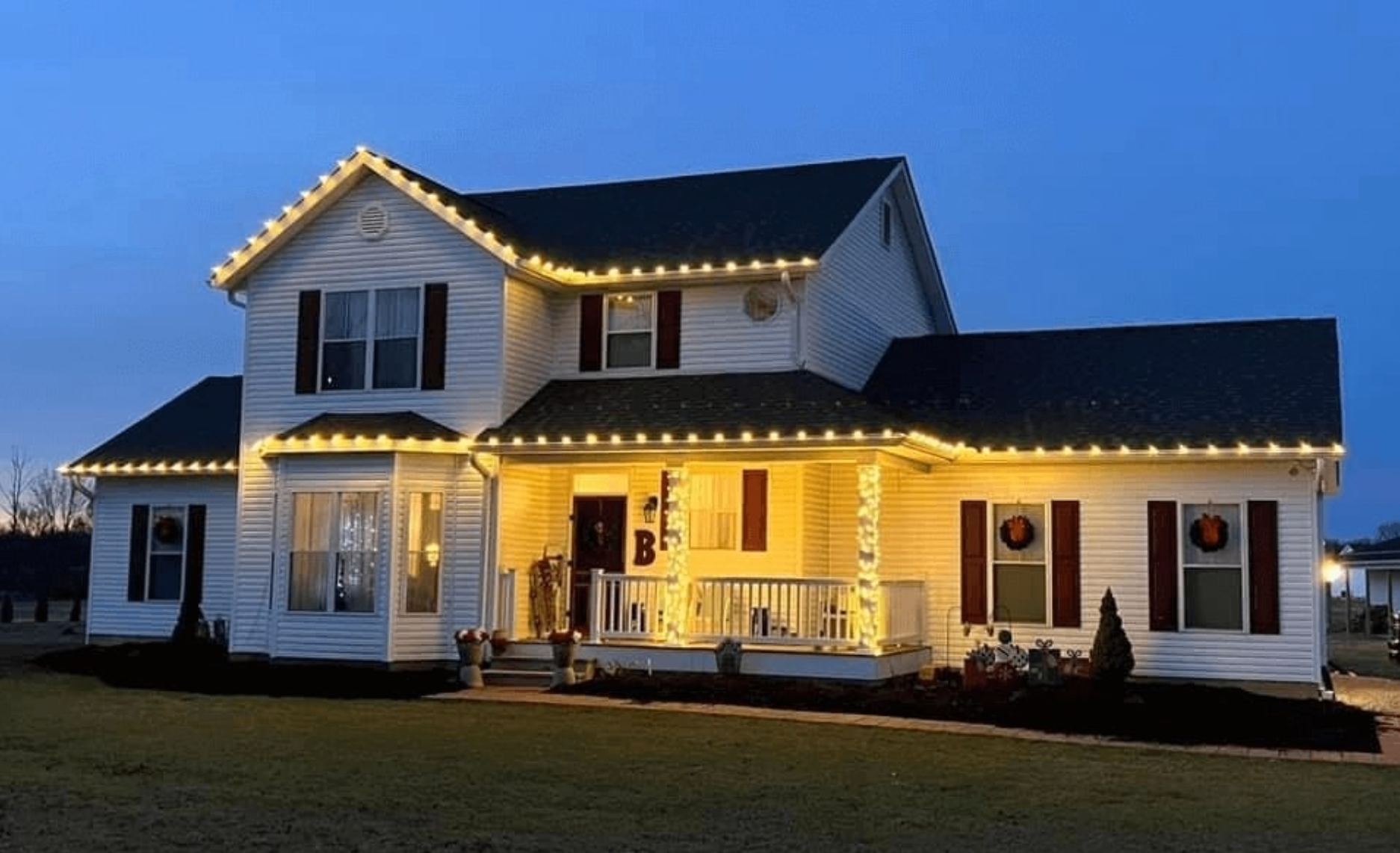Warm-white Christmas lights draped along a roofline and eaves