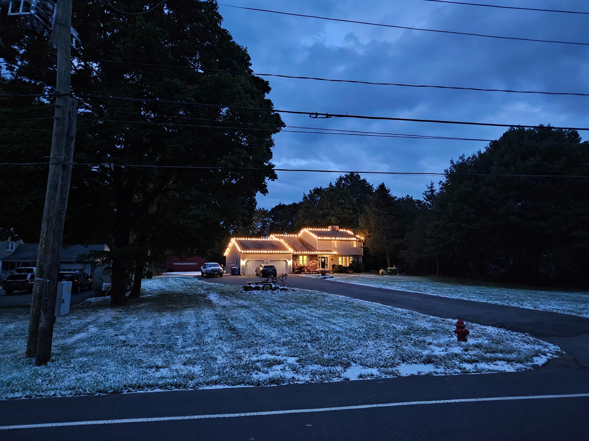 Two-story Connecticut home fully lit with professional Christmas lighting