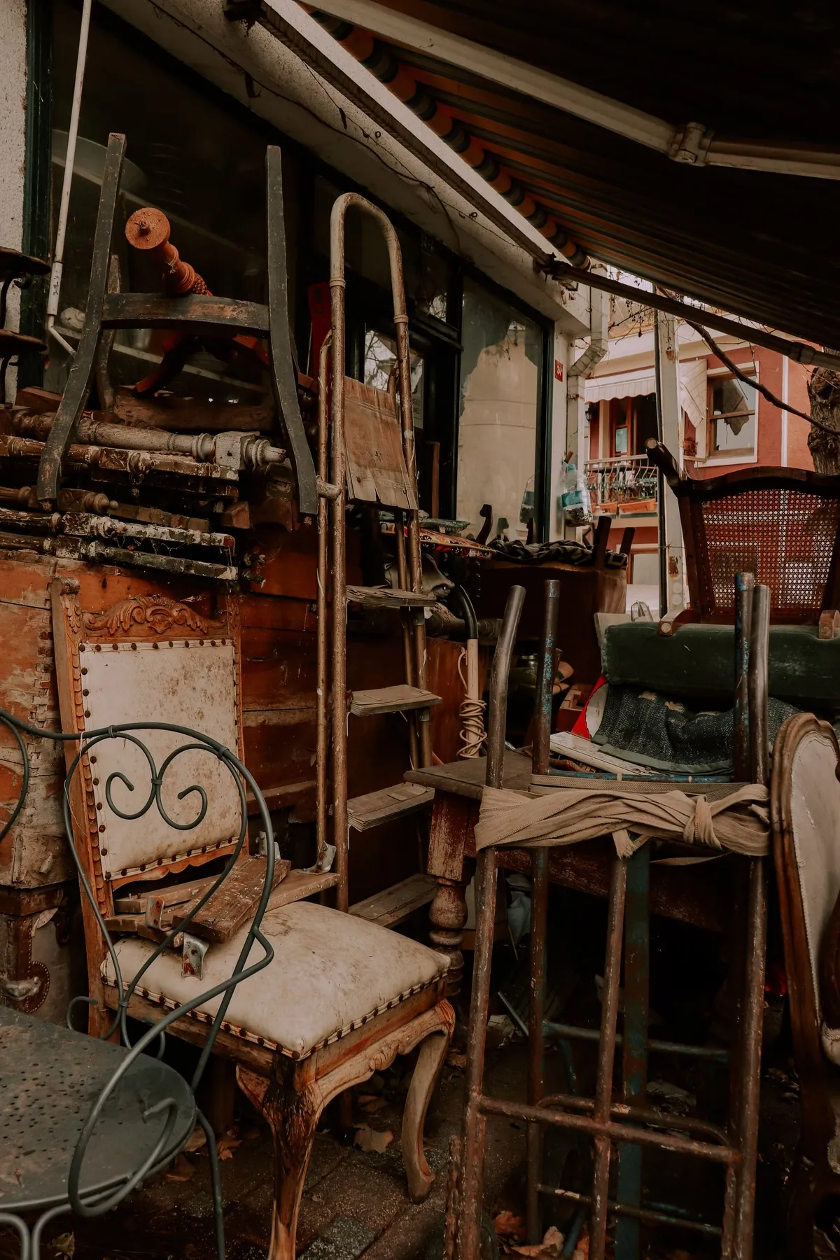 Old abandoned furniture stacked outside waiting for curb side pickup by Mr. Grapple