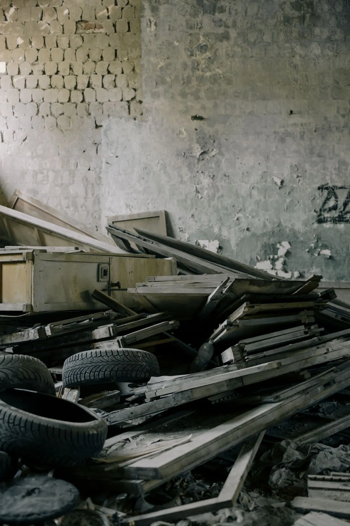 Cluttered abandoned property with broken furniture ready for eviction cleanout by Mr. Grapple