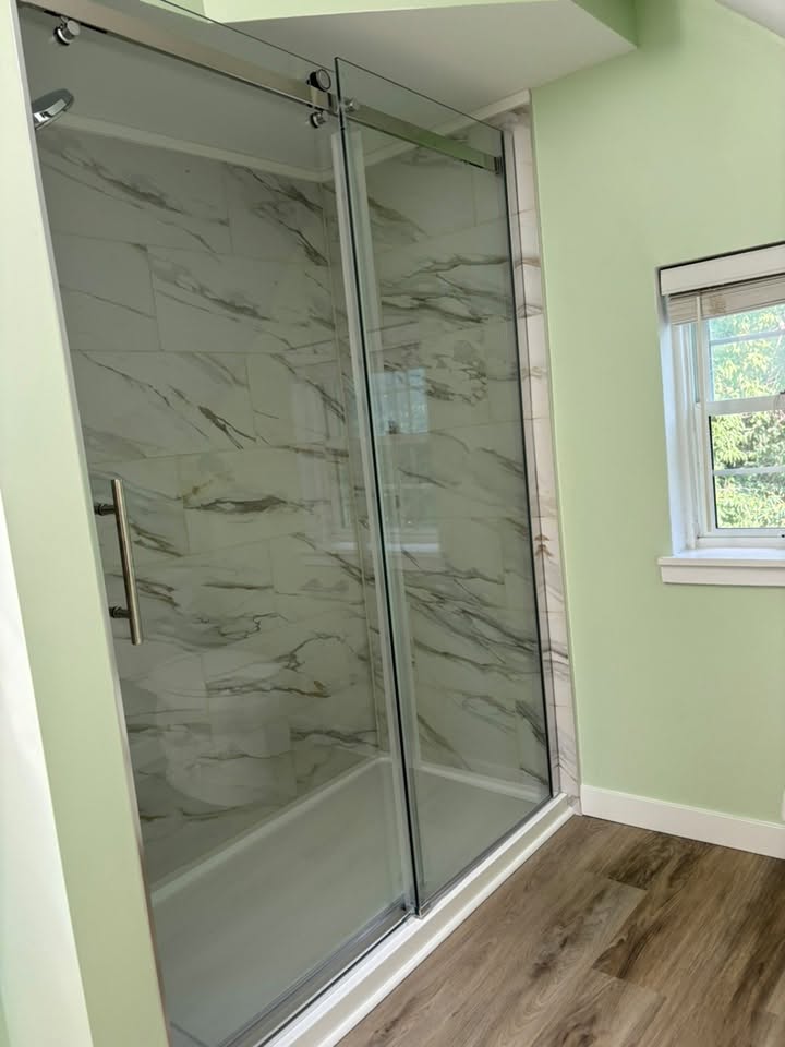 Glass walk-in shower in renovated attic bathroom