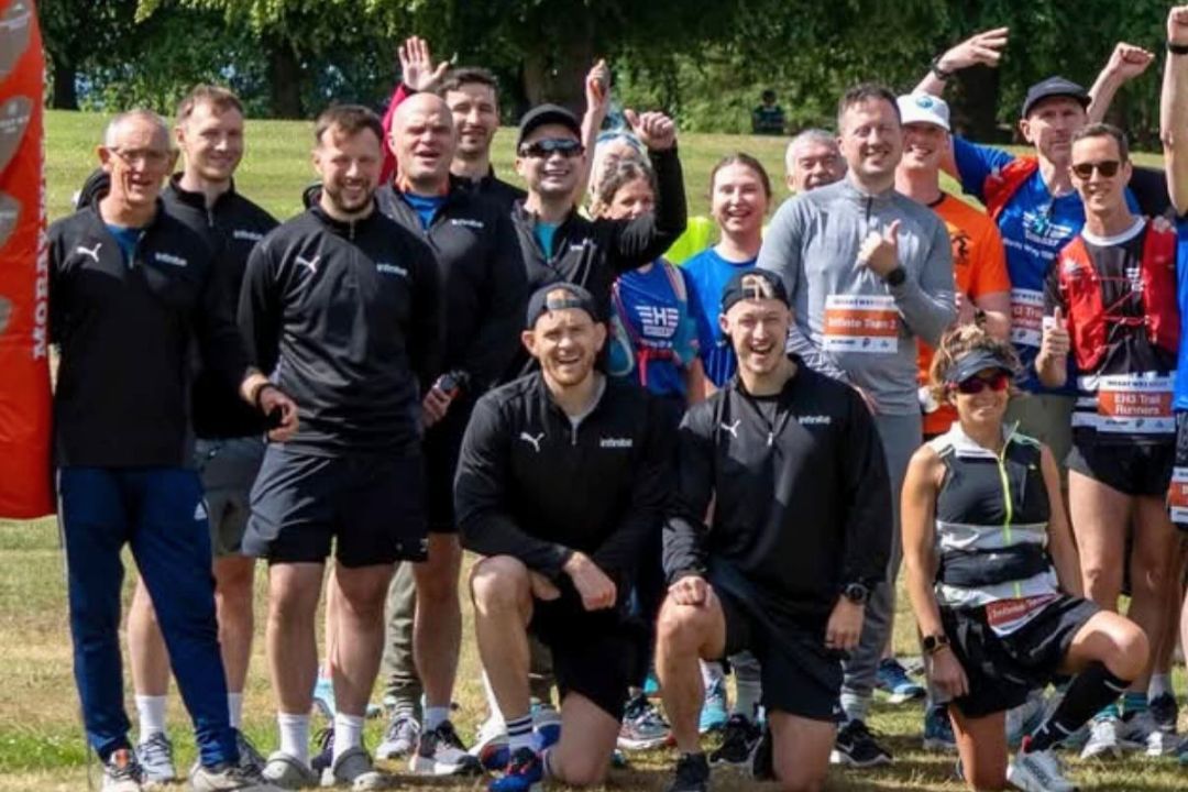 Team Infinite celebrating together at a race