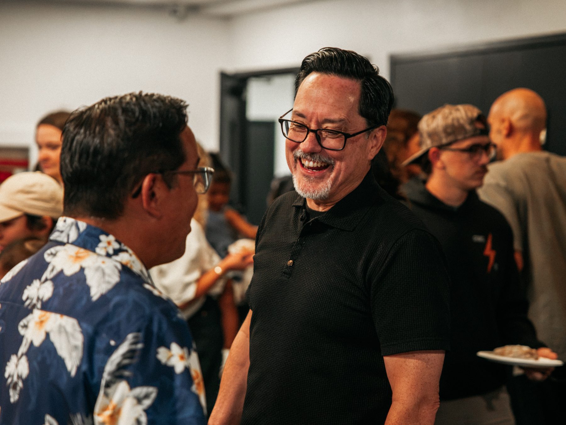 Two men laughing together after a session