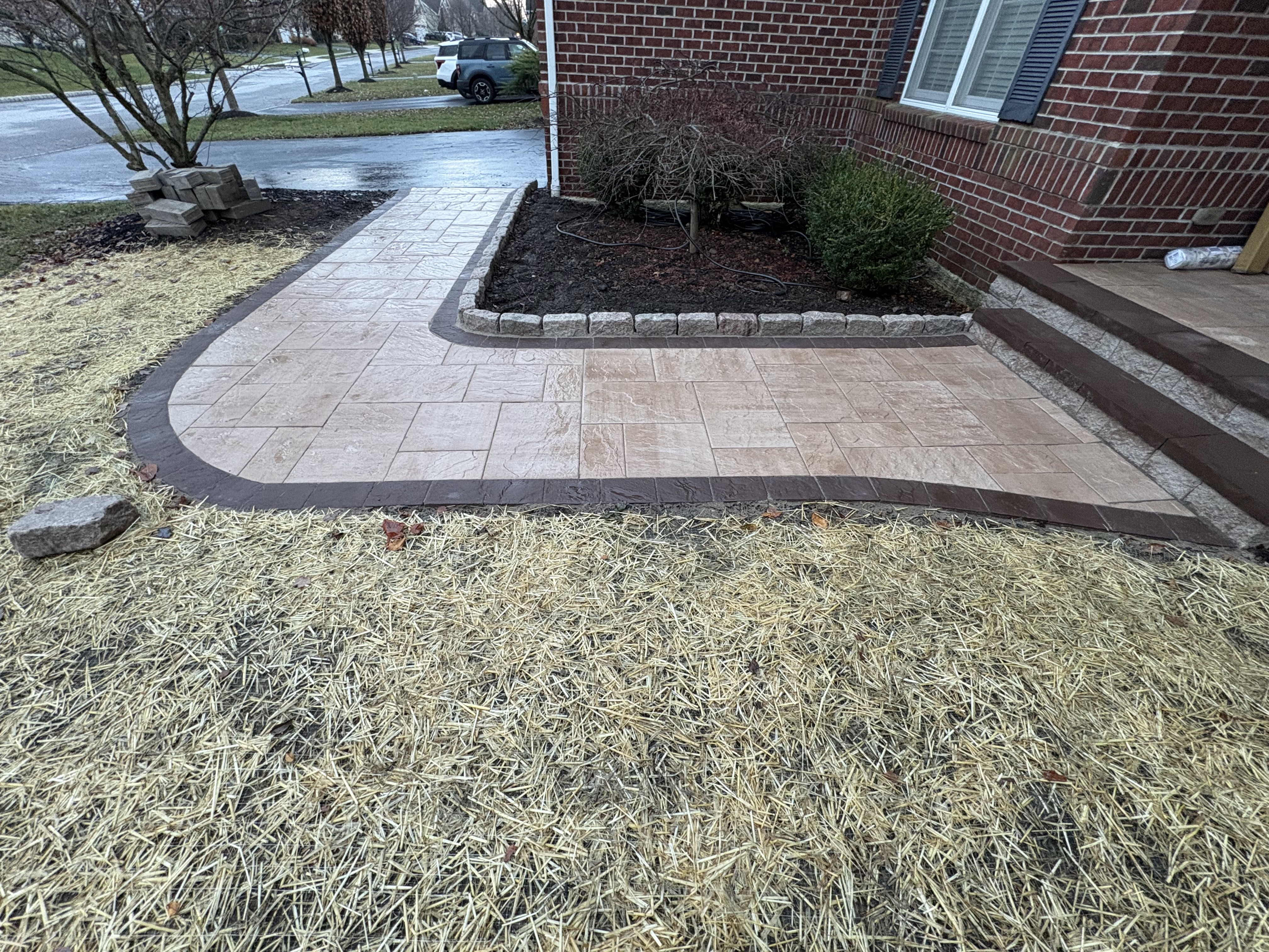 A Chester Springs residential property with a professionally designed landscape featuring layered planting beds, defined lawn areas, and a stone-edged pathway leading to the front entrance. The design reflects the scale and natural surroundings typical of Chester County homes.