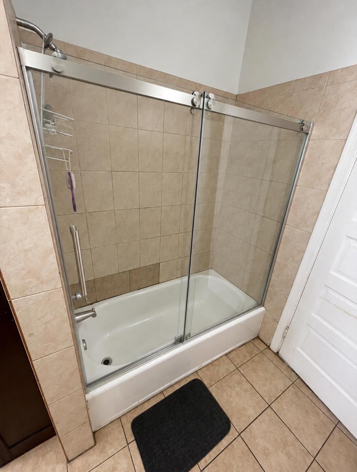 Tub shower: old frosted door to a new frameless glass door (after)