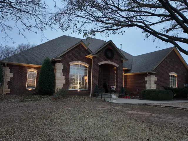 Brick home with trees before lights