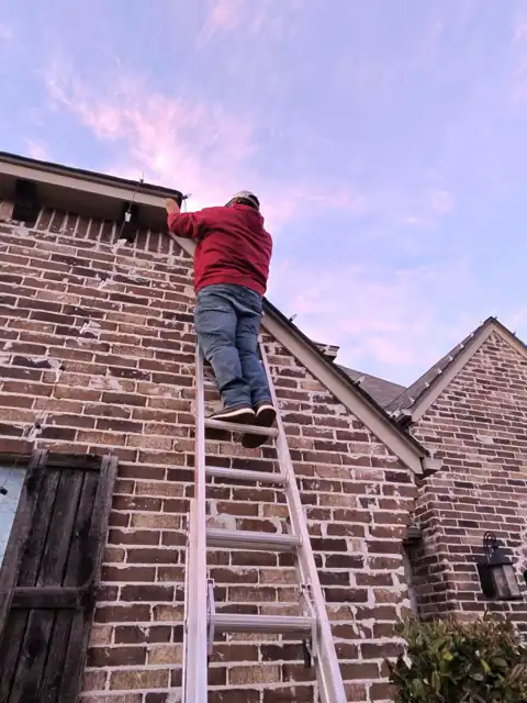Installing Christmas lights on a ladder