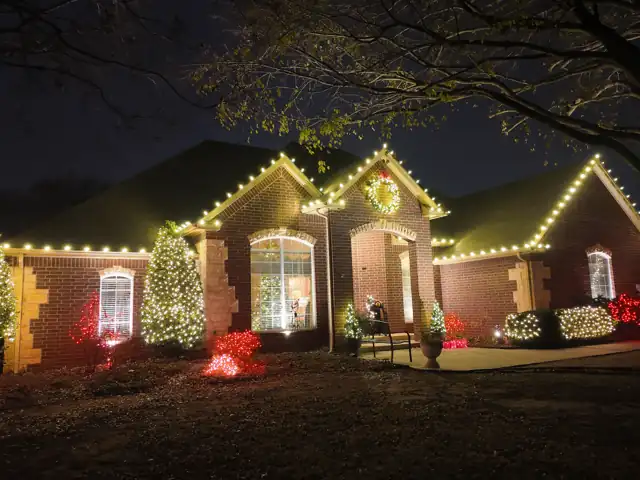 Brick home with trees after lights