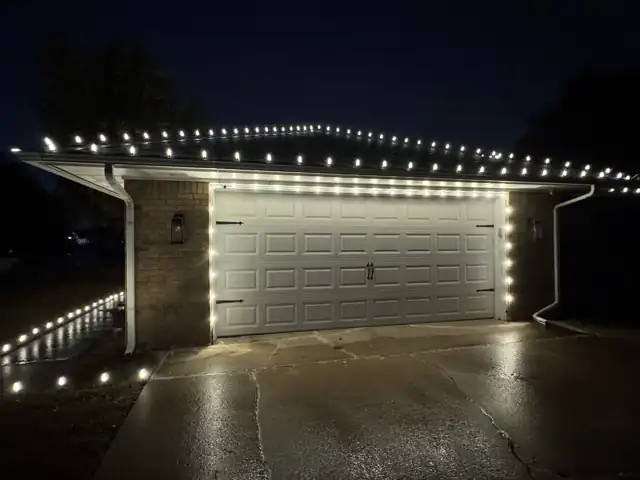 Garage door outlined in Christmas lights