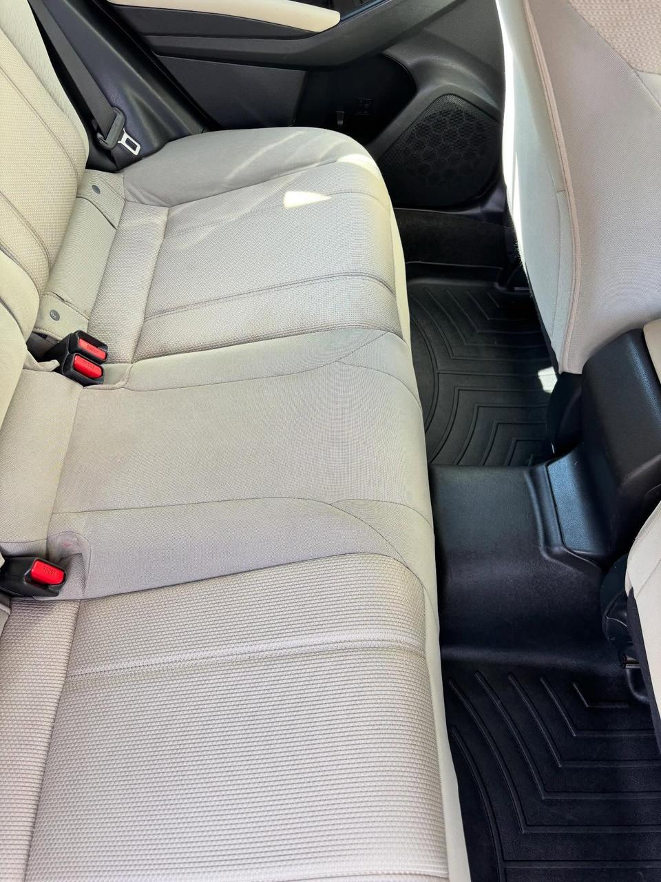 A cloth rear seat, clean and evenly colored after a full interior detail