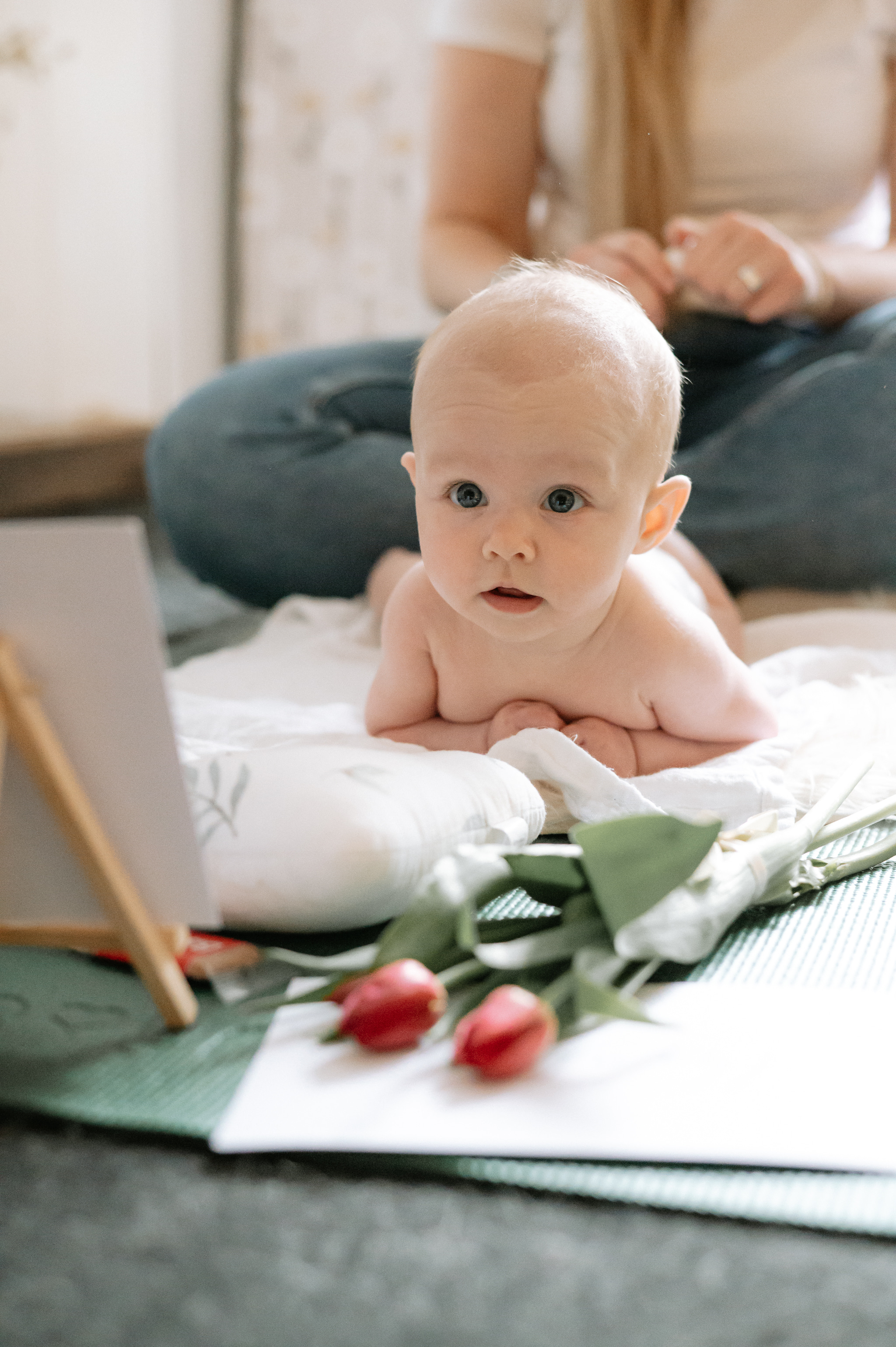 Baby laying on her front having a back massage at a little rosebuds baby massage class