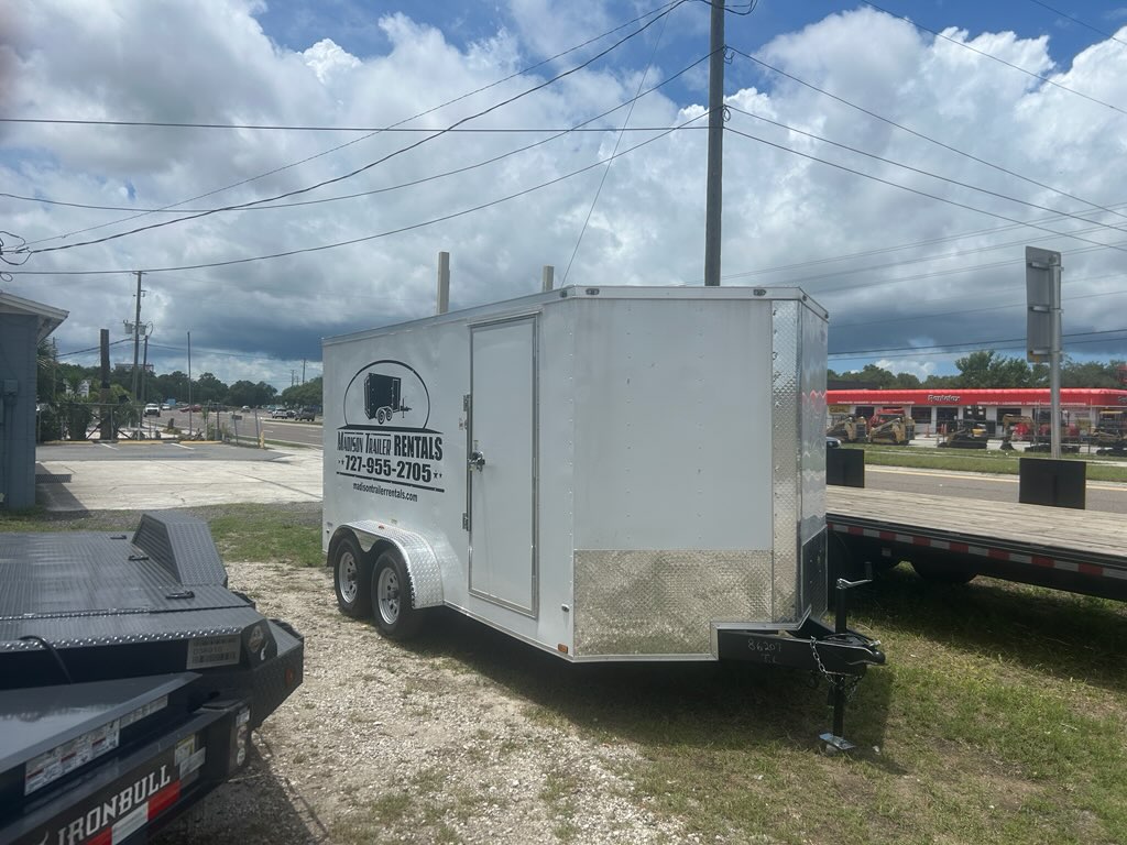 14 ft enclosed trailer parked in driveway, ideal for moving, storage, or business deliveries