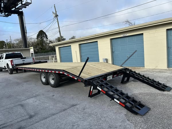 24 ft flatbed trailer with 16K GVWR, designed for hauling heavy-duty equipment and large loads