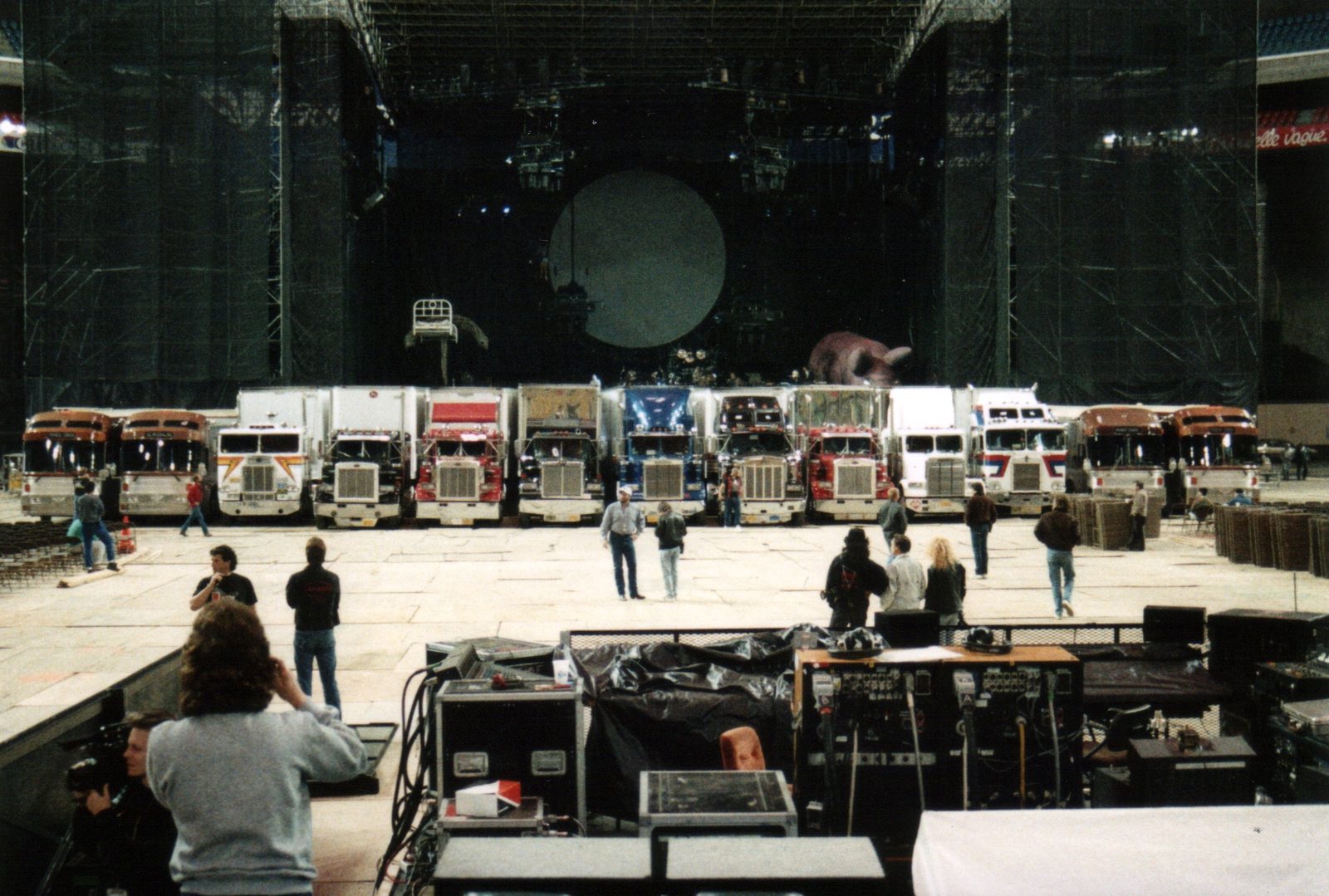 Tour trucks lined up inside an arena