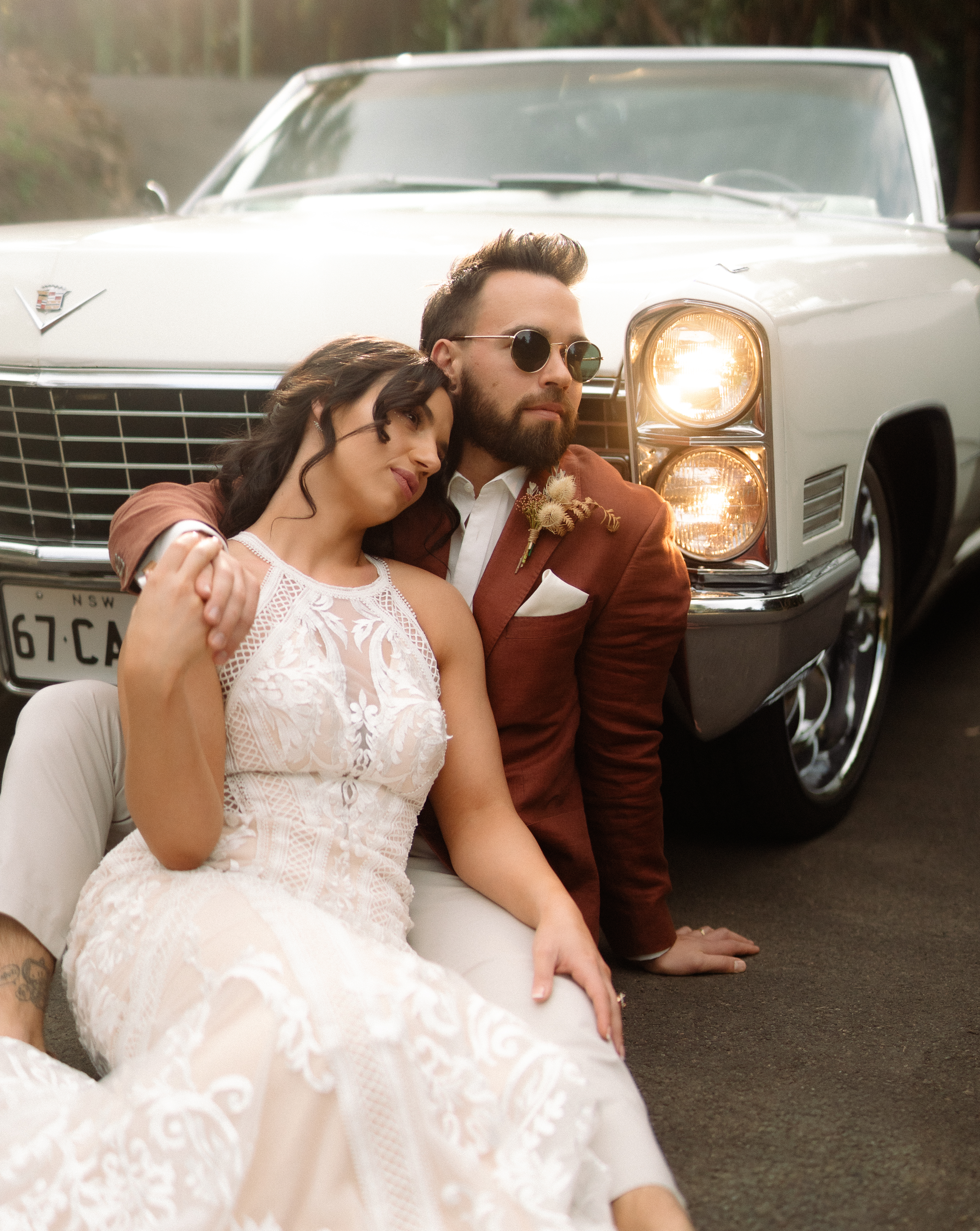 Couple leaning on a vintage Cadillac