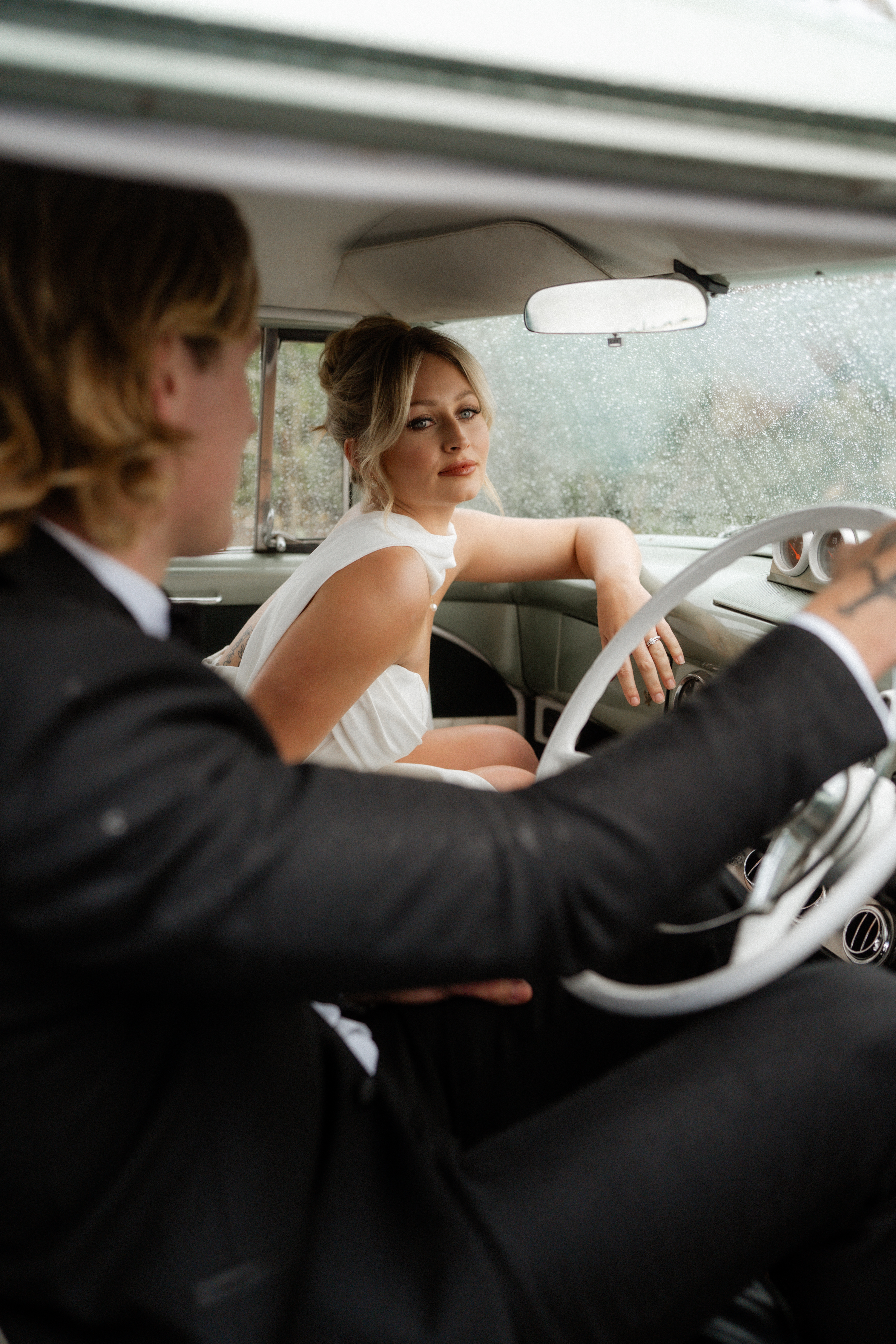 Bride in the passenger seat as they drive away