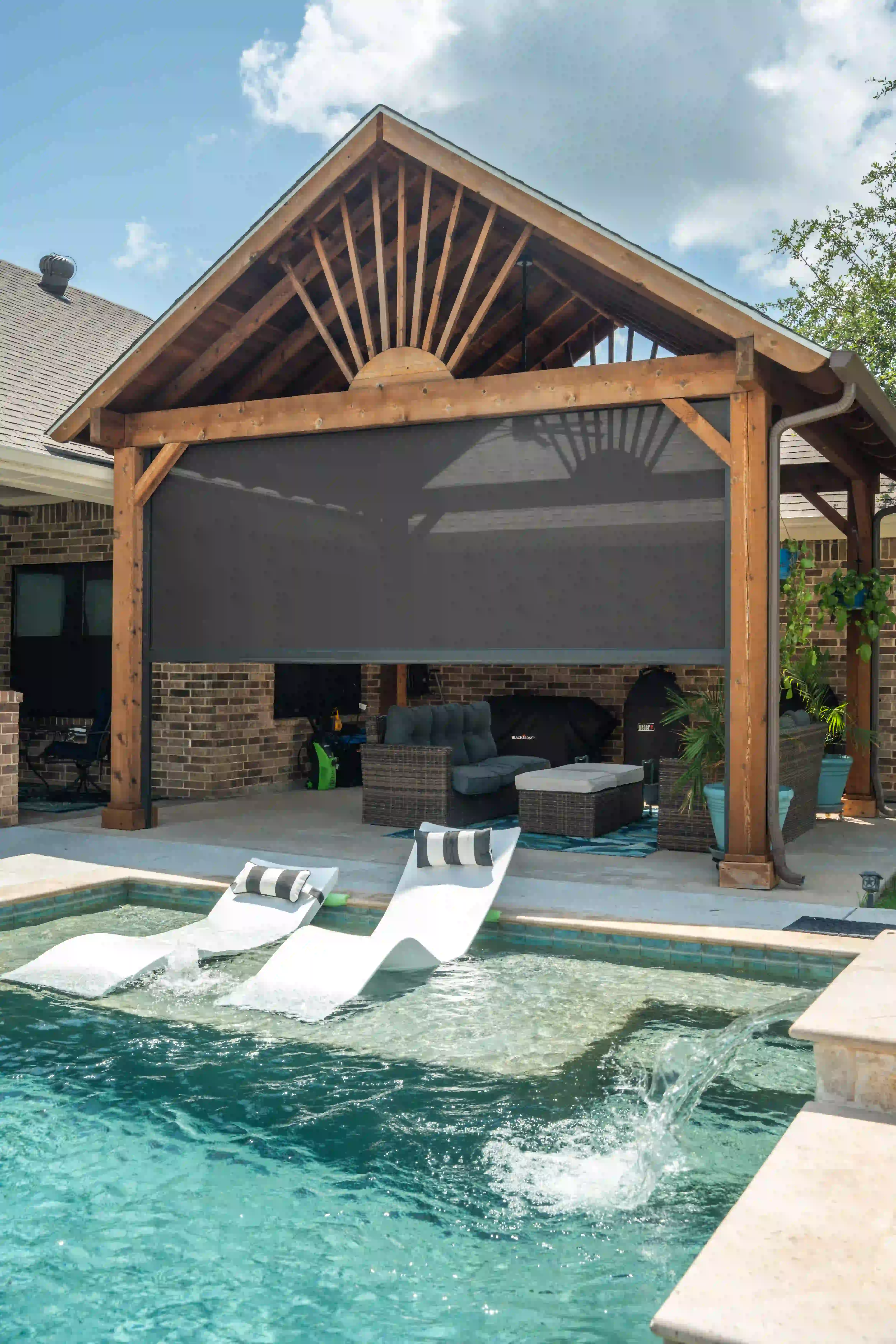 Wood pergola with an extended solar screen over a resort-style pool