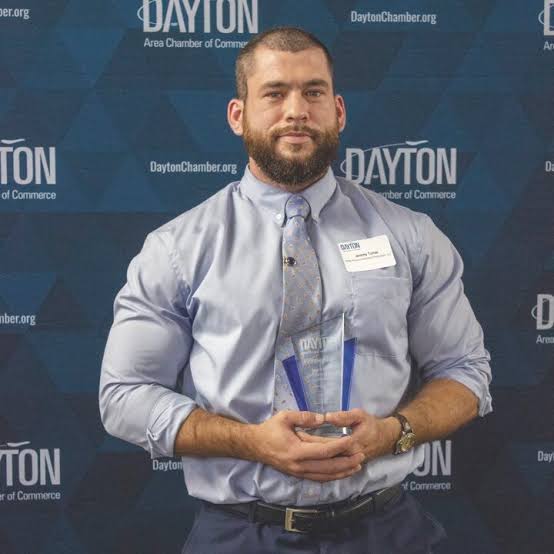 Jeremy Turner holding a Dayton Area Chamber of Commerce award