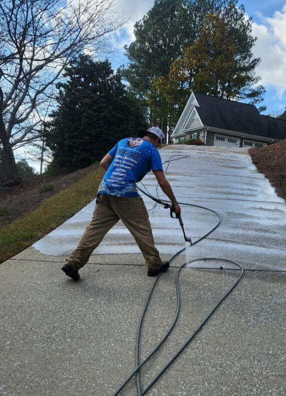 DJ pressure washing a driveway in Cherokee County GA