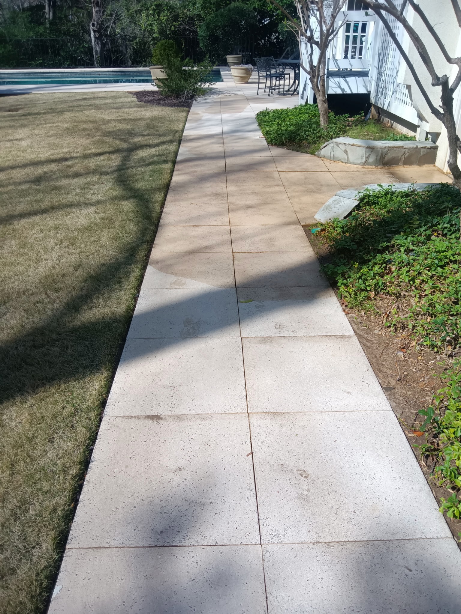 Bright clean concrete walkway after pressure washing by Mechanical Magic in Holly Springs GA